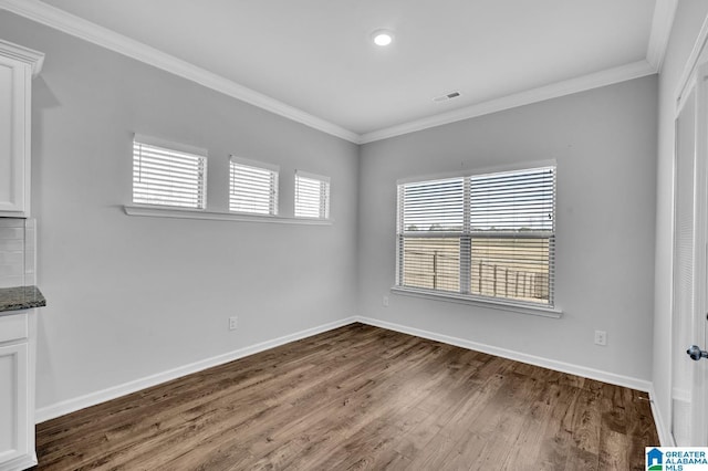 unfurnished room featuring baseboards and ornamental molding