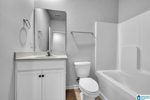 full bathroom featuring baseboards, visible vents, toilet, wood finished floors, and vanity