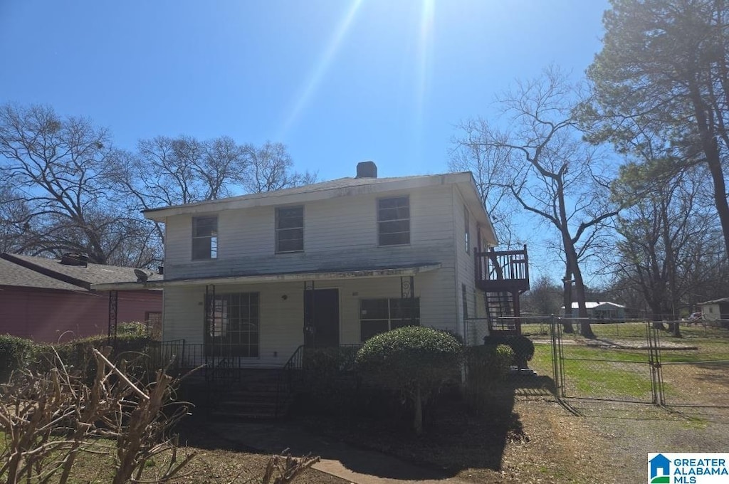 view of front of home with a gate, stairway, and a porch