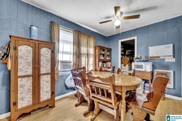 dining area with baseboards, ceiling fan, a textured ceiling, and light wood finished floors