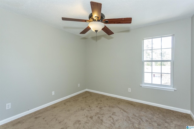 unfurnished room with carpet, a ceiling fan, and baseboards