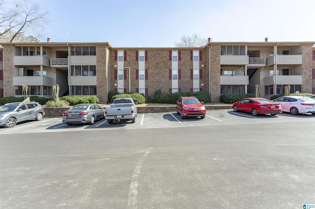 view of building exterior featuring uncovered parking