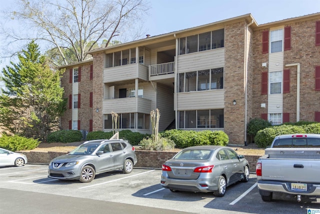 view of building exterior featuring uncovered parking