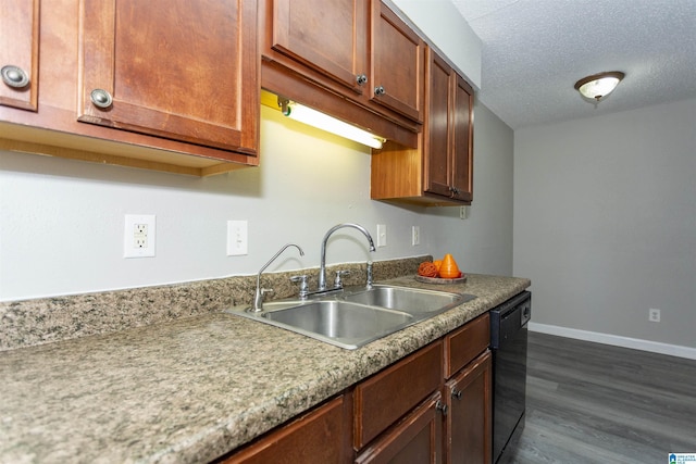 kitchen featuring dark wood-style floors, black dishwasher, a sink, a textured ceiling, and baseboards