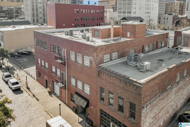 view of property featuring cooling unit and a city view