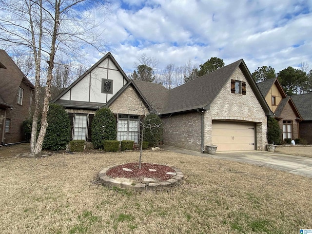 tudor house with driveway, stucco siding, roof with shingles, and brick siding