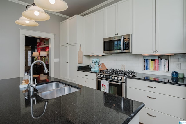 kitchen with decorative backsplash, white cabinetry, stainless steel appliances, and a sink