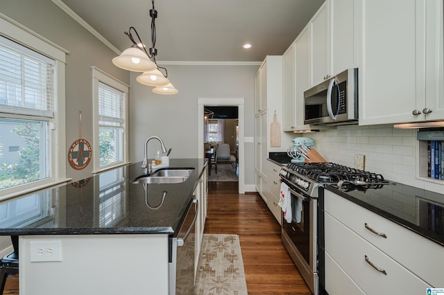 kitchen with a sink, tasteful backsplash, stainless steel appliances, white cabinets, and crown molding