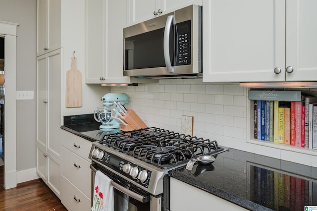 kitchen featuring white cabinetry, dark wood-type flooring, backsplash, and stainless steel appliances