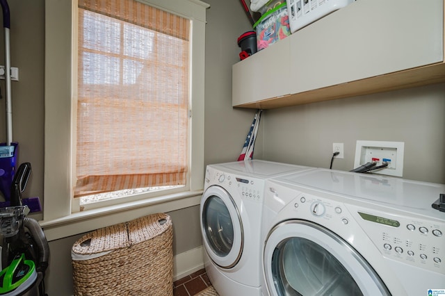 laundry area with a wealth of natural light, baseboards, cabinet space, and washer and clothes dryer