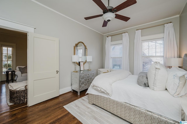 bedroom featuring dark wood finished floors, ceiling fan, baseboards, and ornamental molding