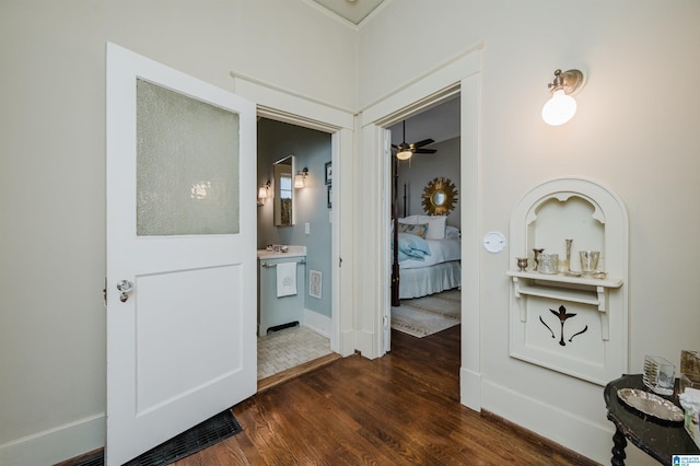 hallway featuring baseboards and dark wood finished floors