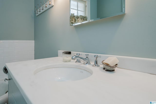 bathroom featuring tile walls and vanity