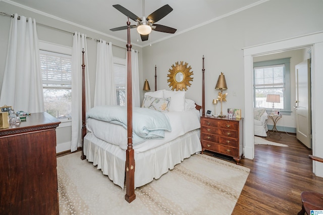 bedroom with a ceiling fan, wood finished floors, baseboards, and ornamental molding