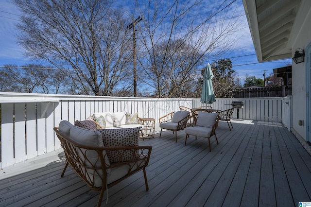 wooden terrace with an outdoor hangout area