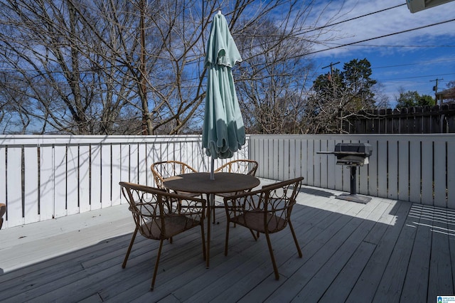 deck featuring grilling area and outdoor dining space