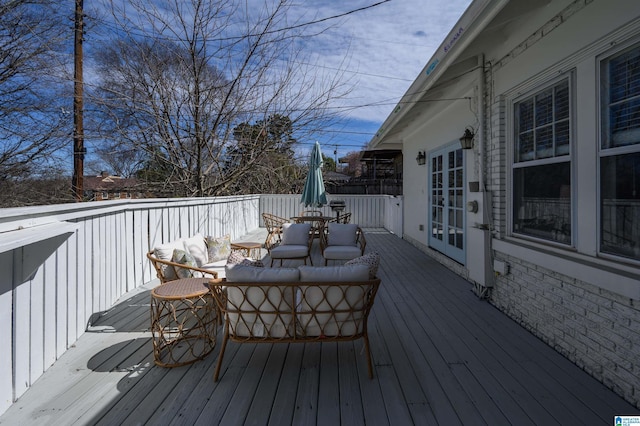 wooden deck with french doors and outdoor lounge area