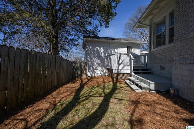 view of yard featuring a deck and fence