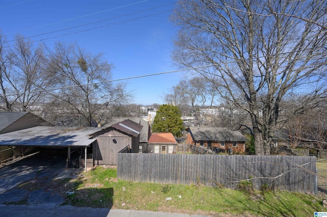 view of yard with a carport and fence