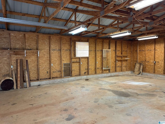 miscellaneous room featuring vaulted ceiling and unfinished concrete floors