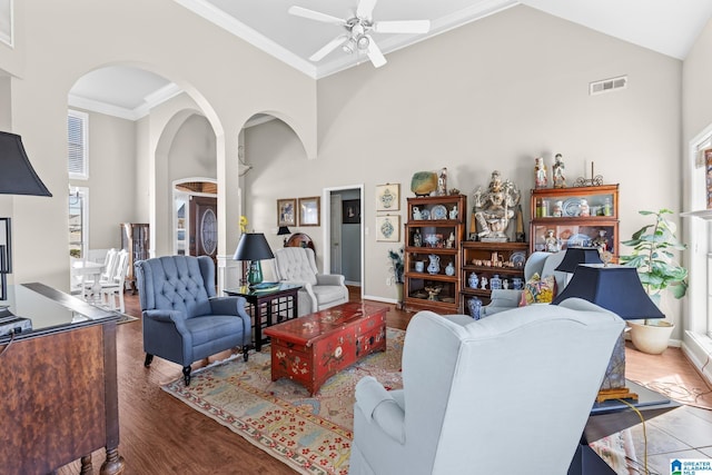 living room with high vaulted ceiling, visible vents, plenty of natural light, and wood finished floors