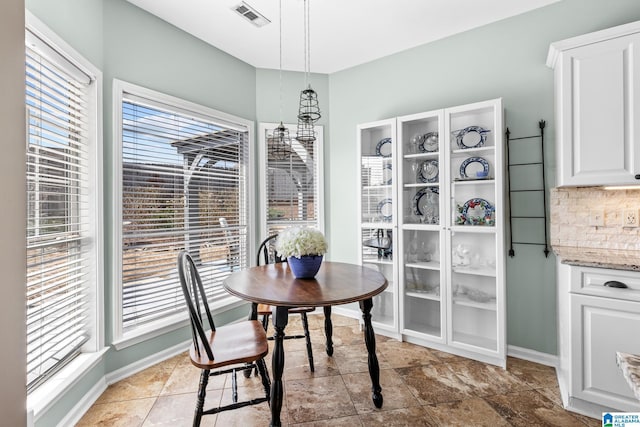 dining space with baseboards and visible vents