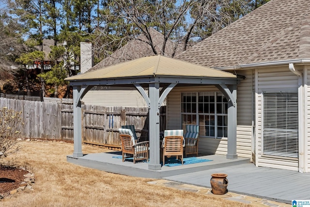 view of patio featuring fence and a gazebo