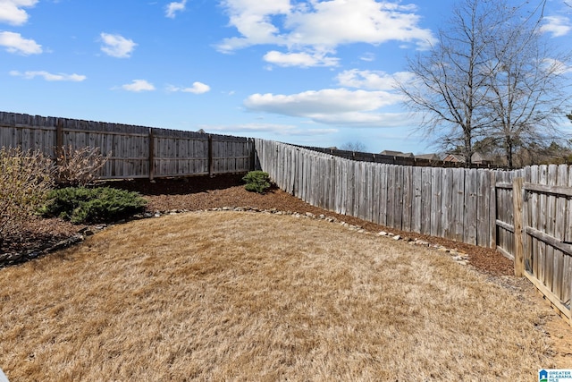 view of yard with a fenced backyard