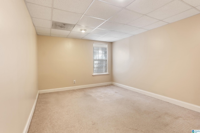 unfurnished room featuring a paneled ceiling, baseboards, and carpet flooring