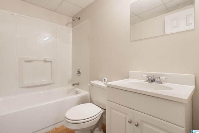 bathroom featuring toilet, shower / bathtub combination, vanity, and a paneled ceiling