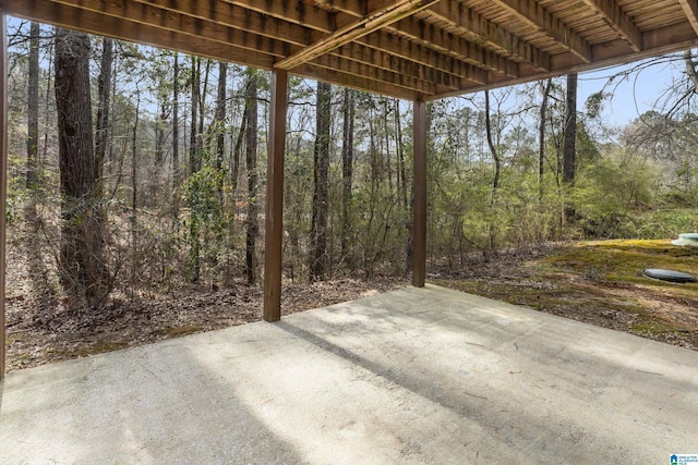 view of patio featuring a wooded view