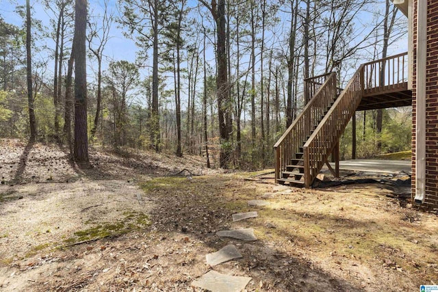 view of yard with stairway and a deck