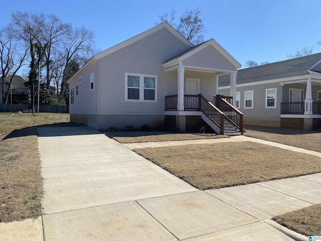 view of front of house featuring driveway and a porch