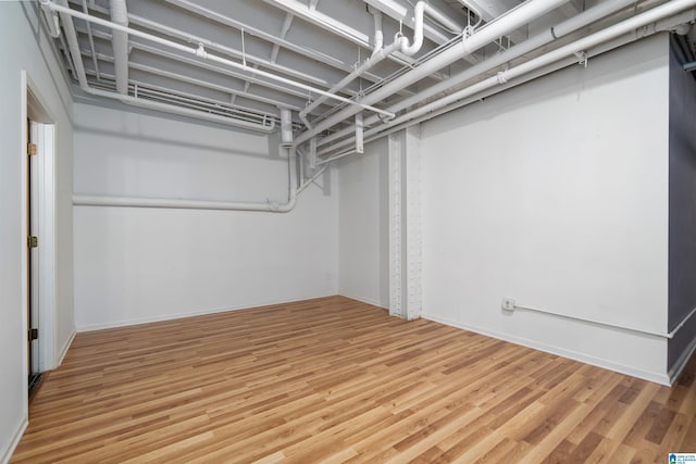 finished basement featuring baseboards and wood finished floors