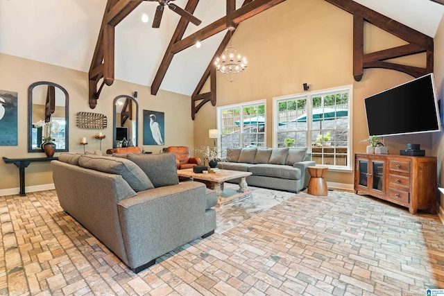 living room featuring baseboards, beamed ceiling, brick floor, high vaulted ceiling, and ceiling fan with notable chandelier