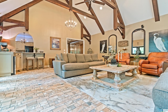 living room featuring brick floor, arched walkways, high vaulted ceiling, beamed ceiling, and ceiling fan with notable chandelier