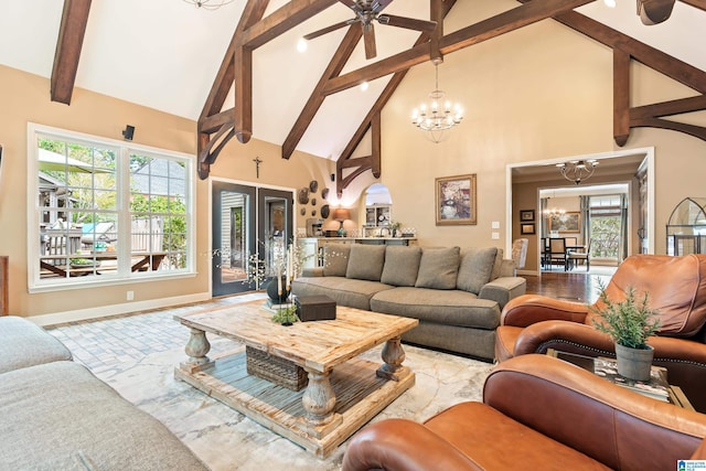 living area with high vaulted ceiling, a healthy amount of sunlight, beamed ceiling, and baseboards