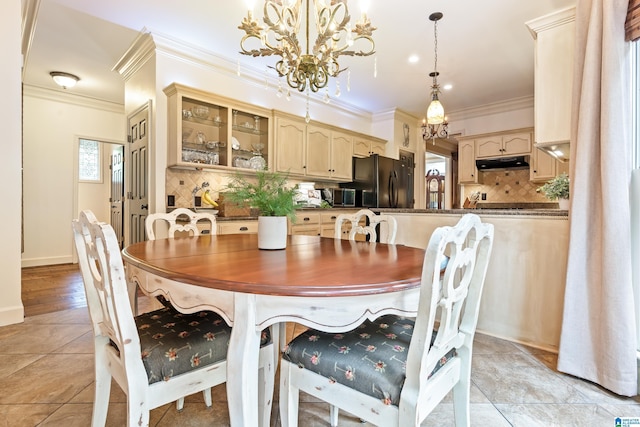 dining room featuring light tile patterned floors, crown molding, and an inviting chandelier