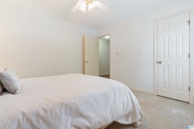 bedroom featuring a ceiling fan, light colored carpet, and baseboards