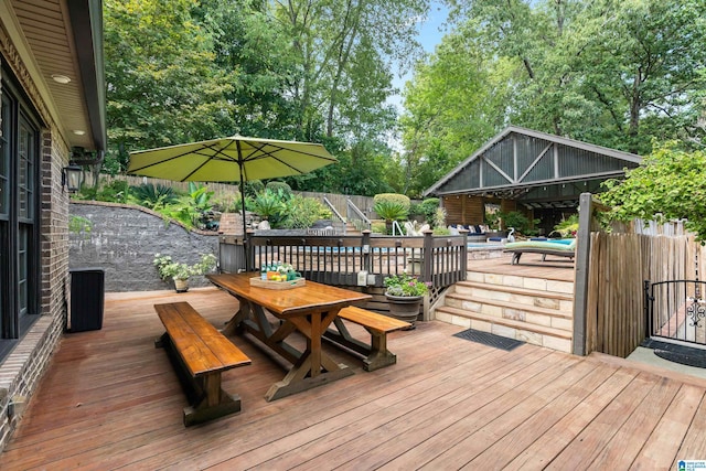 deck featuring a fenced in pool, outdoor dining area, and fence