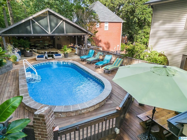 outdoor pool with outdoor dining space and a deck