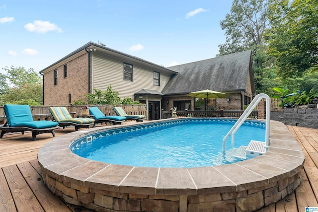 view of pool featuring a fenced in pool and a deck