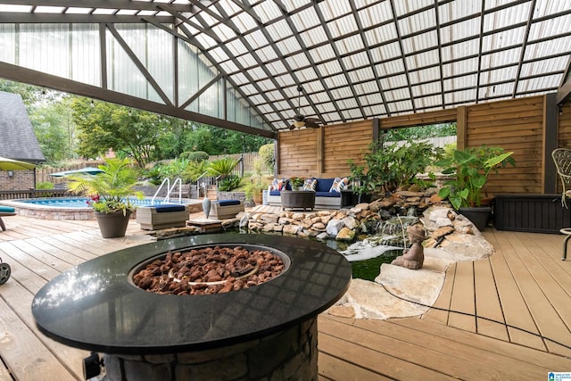 wooden terrace featuring an outdoor fire pit