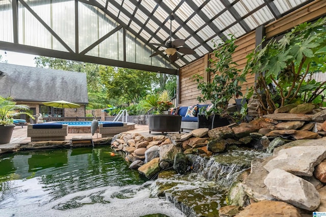 view of patio featuring fence, an outdoor pool, and a ceiling fan