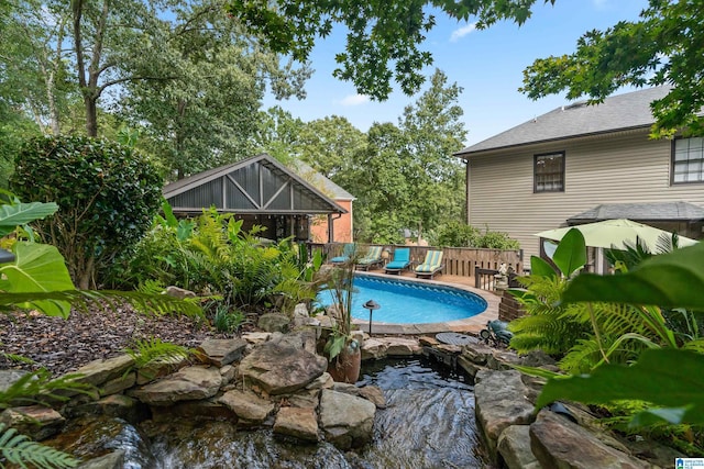 view of swimming pool featuring fence and a fenced in pool