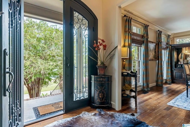 entryway featuring baseboards and wood finished floors