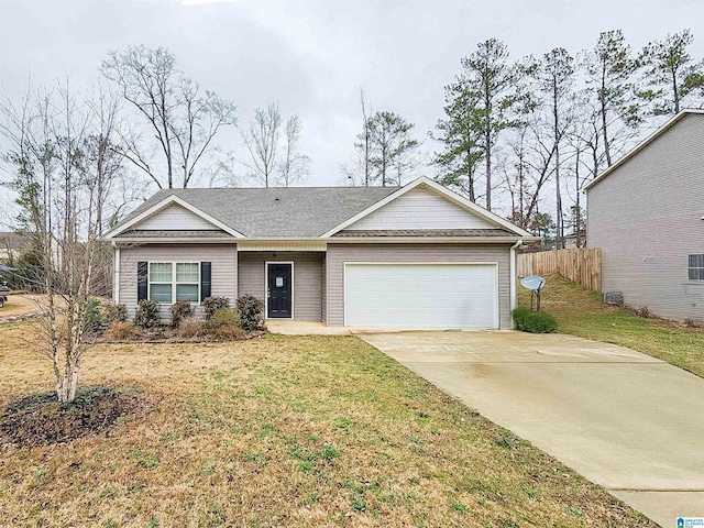 ranch-style house with an attached garage, driveway, fence, and a front lawn