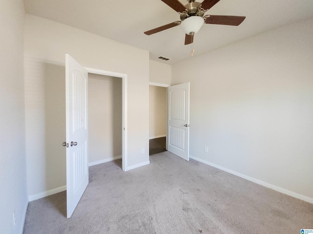 unfurnished bedroom featuring ceiling fan, carpet, visible vents, and baseboards