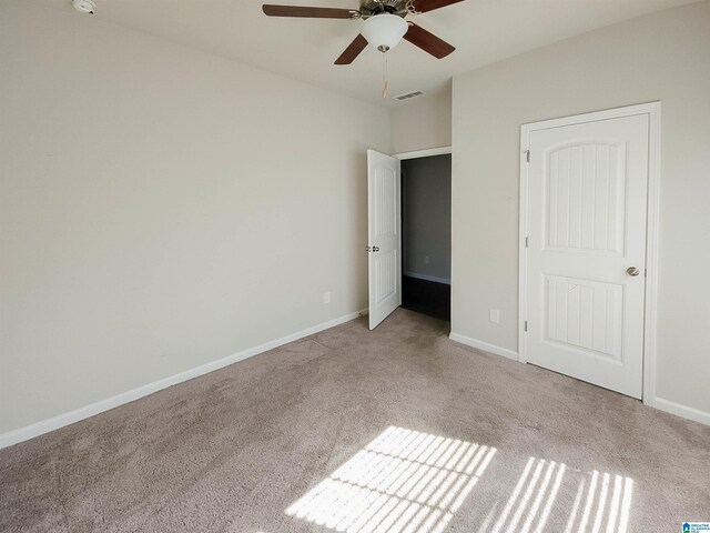 unfurnished bedroom with baseboards, visible vents, ceiling fan, and carpet flooring