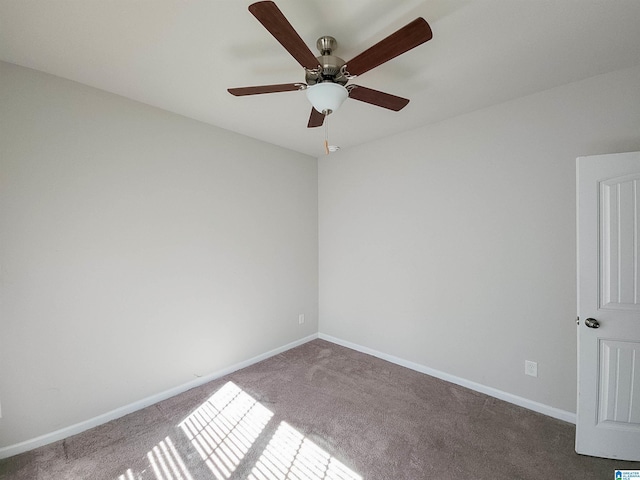 unfurnished room featuring carpet and baseboards